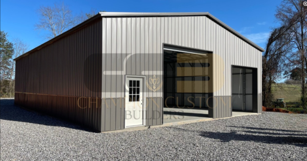 40’x60’x14’ custom steel building with a large roll-up door, walk-in door, and open interior space.